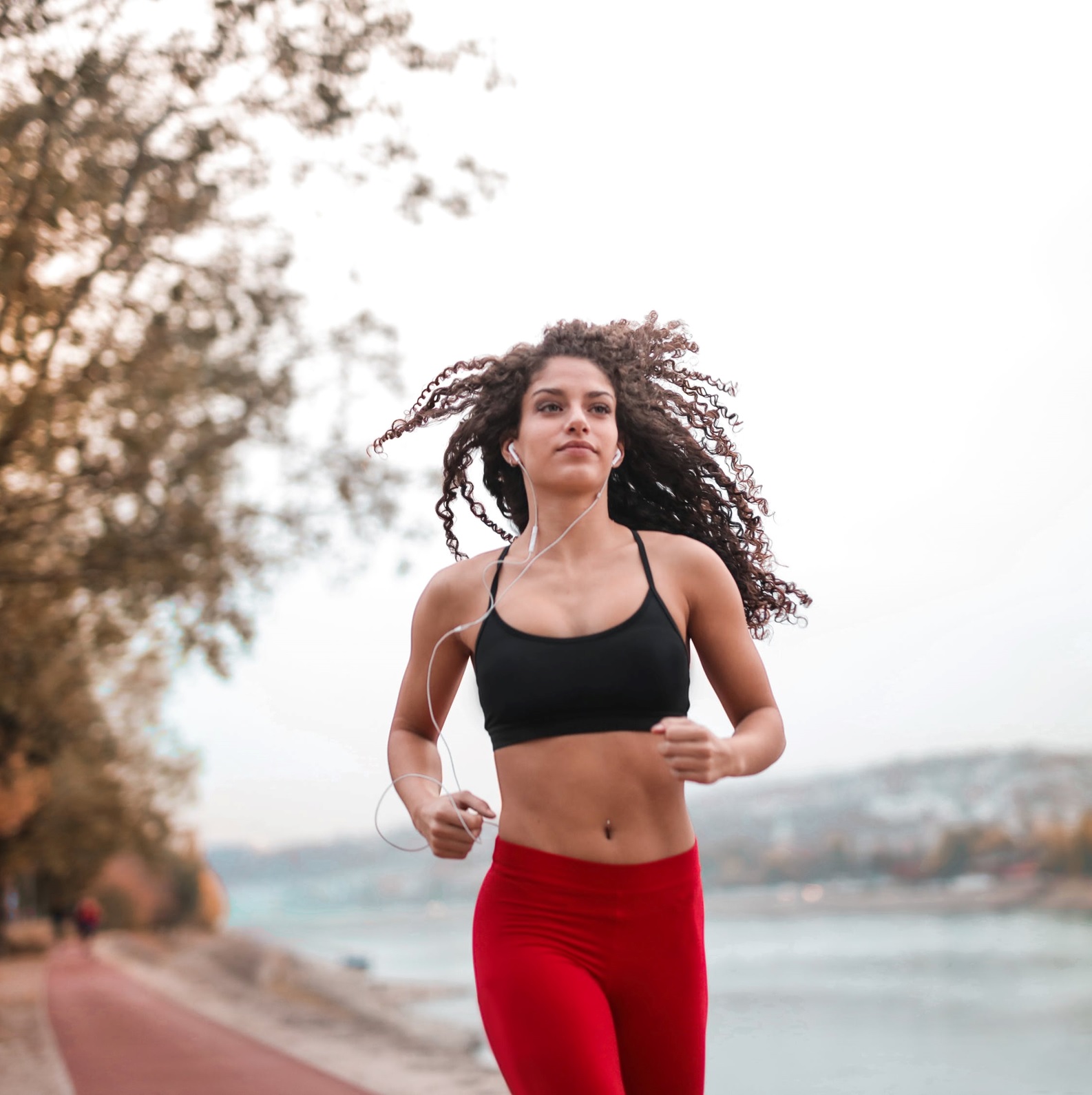 Blonde Female Athlete Stretching In Workout Attire Before Her Run