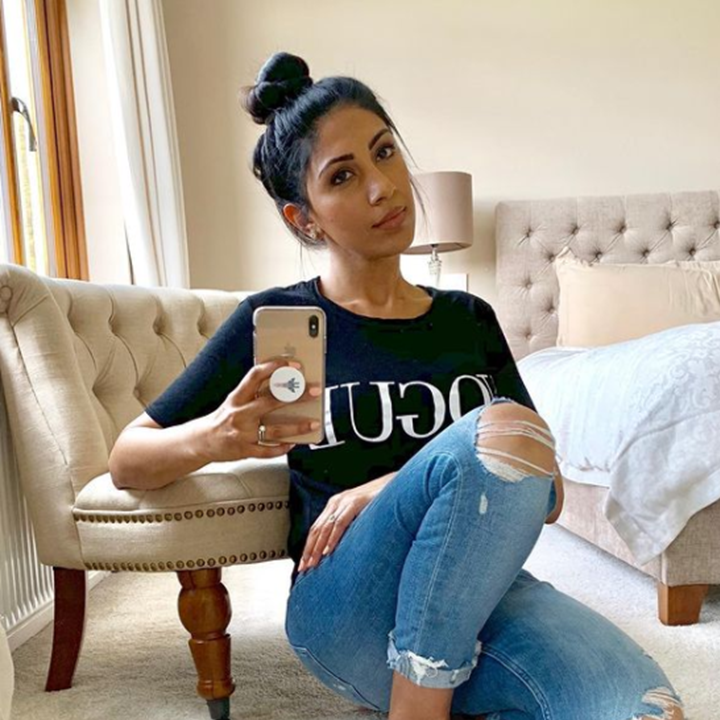 Teen girl posing in city wearing casual outfit: shorts, blue jeans jacket  and white sneakers. Portrait of female with trendy bun hairstyle sitting  nea Stock Photo - Alamy